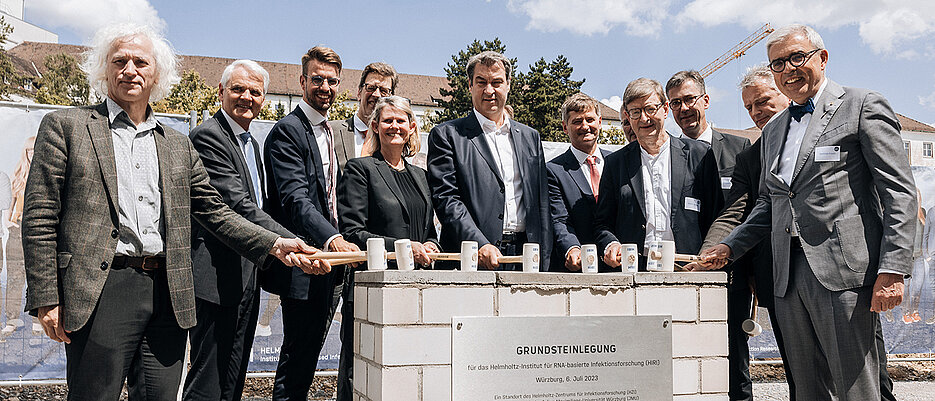 Grundsteinlegung des Helmholtz-Instituts Würzburg. Von links: Prof. Josef Penninger (HZI), Prof. Dirk Heinz (HZI), Dr. Renke Deckarm (EU-Kommission), Christian Scherf (HZI, im Hintergrund), Staatssekretärin Judith Pirscher (BMBF), Ministerpräsident Dr. Markus Söder (Freistaat Bayern), Prof. Jörg Vogel (HIRI), Dipl.-Ing. Rainer Post (doranth post architekten, im Hintergrund), Prof. Otmar D. Wiestler (Helmholtz-Gemeinschaft), Oberbürgermeister Christian Schuchardt (Würzburg), Staatssekretär Roland Weigert (StMWi), Prof. Matthias Frosch (JMU). 