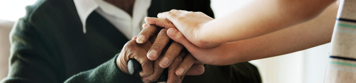 Grandson holding grandpa's hands