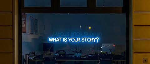 TV Screen saying "What's you story?"