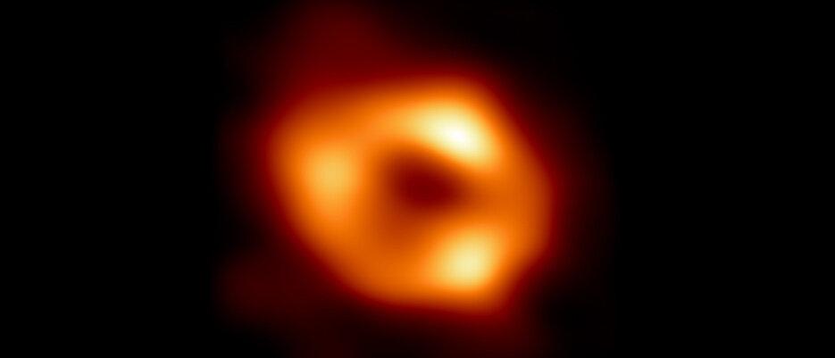 This is the first image of Sagittarius A*, the supermassive black hole at the centre of our galaxy. It shows glowing gas orbiting around the black hole, revealing a telltale signature: a dark central region (called a 