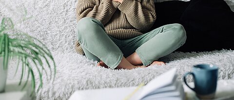 Relaxation techniques: Woman practicing pranayama in lotus position on bed, breathing exercises to reduce stress and anxiety, achieving inner balance and harmony, mindfulness and meditation practice.