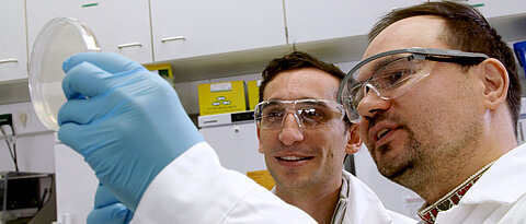 Chase Beisel (center) and Oleg Dmytrenko in the HIRI lab. 