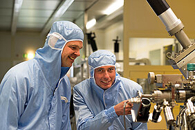 Martin Kamp and Professor Sven Höfling working in the highly controlled environment of the University of Würzburg's cleanroom.