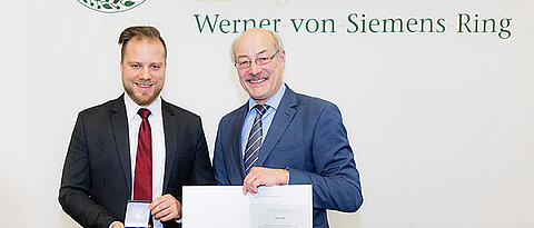 Der Würzburger Doktorand Oliver Ruf erhielt seine Auszeichnung von Joachim Ullrich, dem Vorsitzende des Stiftungsrates der Stiftung Werner von Siemens Ring.