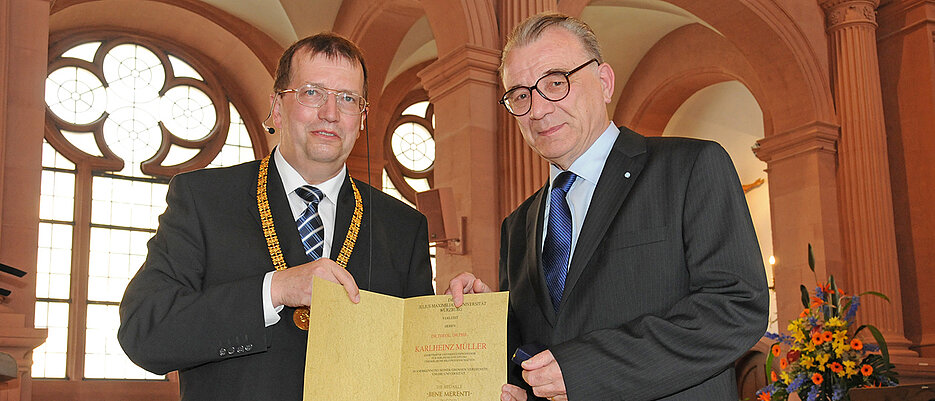Professor Karlheinz Müller (r.) im Jahr 2011, als er beim Stiftungsfest von JMU-Präsident Alfred Forchel die Verdienstmedaille „Bene Merenti“ in Gold verliehen bekam.