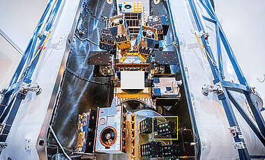 Die SpaceX-Rakete mit ihrem Gepäck kurz vor dem Start. Im gelben Rahmen zu sehen ist SONATE-2, der Satellit der Uni Würzburg.