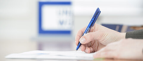 Hand mit Stift beim Schreiben