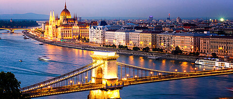 The Hungarian Parliament and the Chains Bridge in Budapest at sunset.