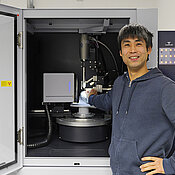 Crystallographer Dr Kazutaka Shoyama in front of his working tool, a single crystal diffractometer. 